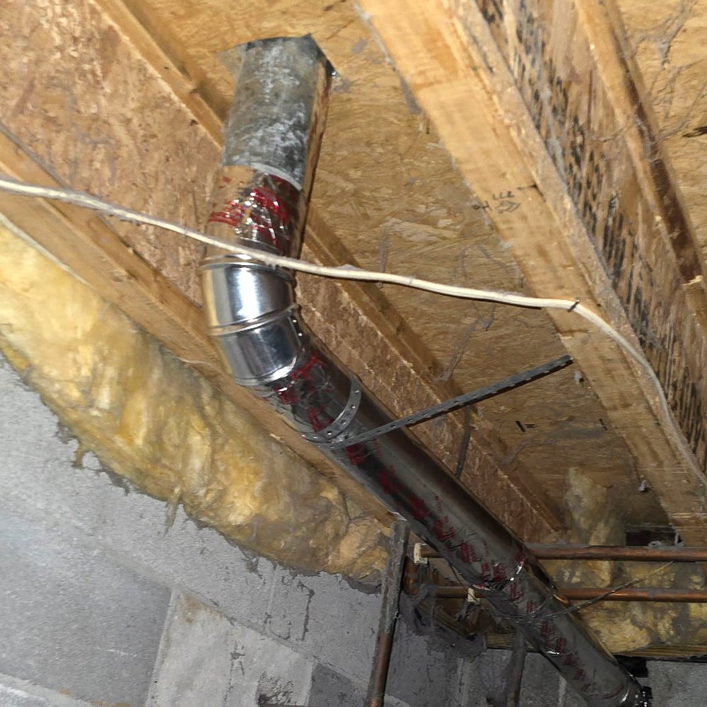 A new rigid metal dryer duct, foil sealed at the joints and strapped to the floor joists